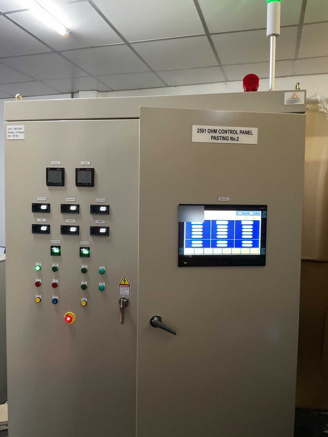 Finished PLC control panel with door-mounted HMI and tower light