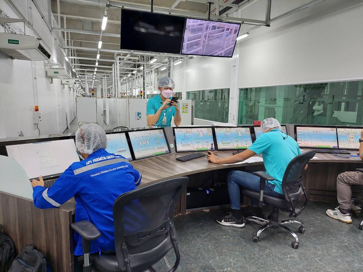SCADA control room with operators at monitoring stations